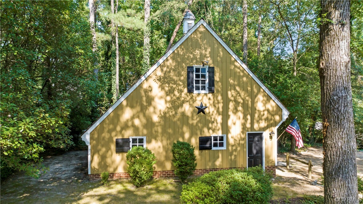 9737 Cole Mill Road Richmond, VA 23237 - Photo 37 of 50 a view of house with a small yard and large trees