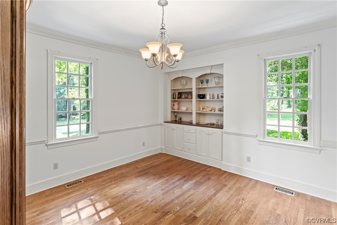 9737 Cole Mill Road Richmond, VA 23237 - Photo 43 of 50 a view of an empty room with a window and wooden floor
