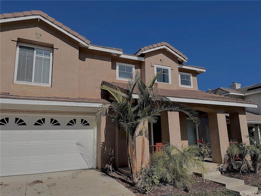 651 Pointe Vista Lane Corona, CA 92881 - Photo 1 of 19 a front view of a house with garage