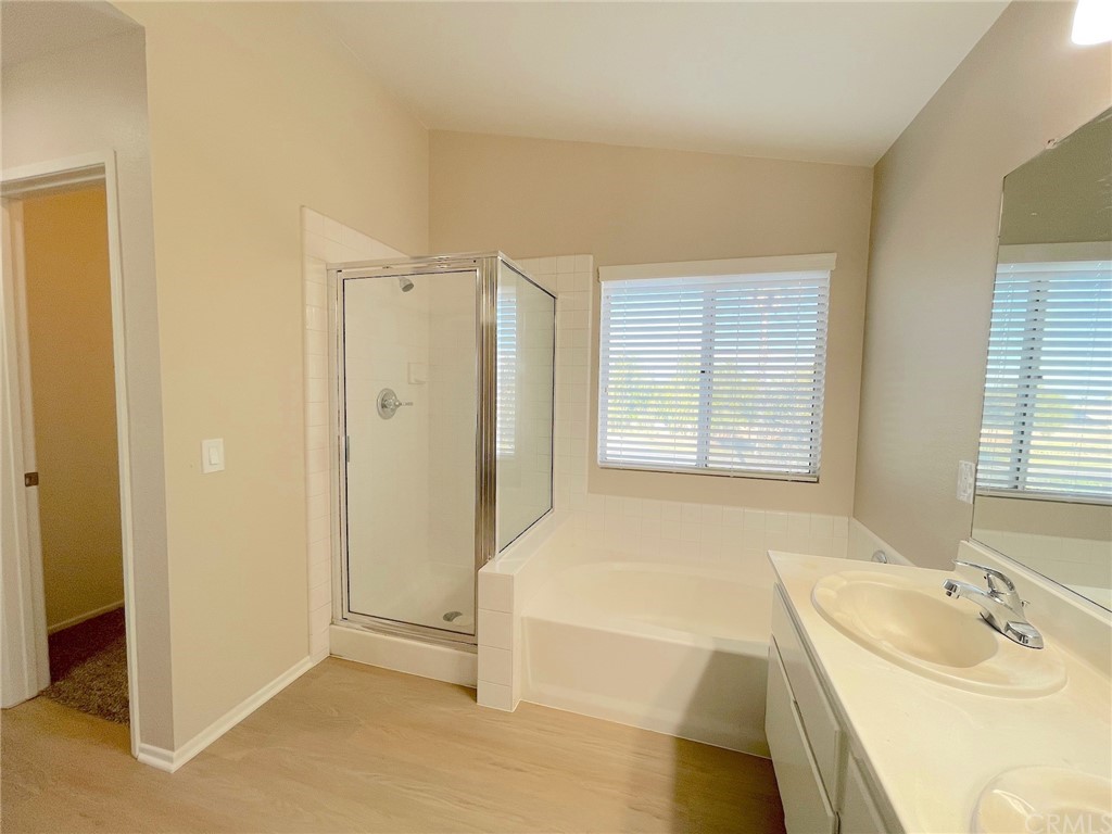651 Pointe Vista Lane Corona, CA 92881 - Photo 13 of 19 a spacious bathroom with a tub sink and mirror