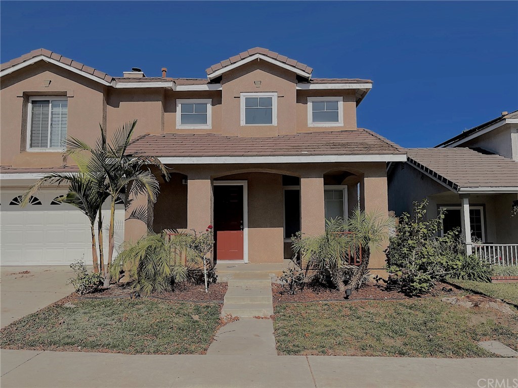 651 Pointe Vista Lane Corona, CA 92881 - Photo 2 of 19 a front view of a house with a yard and garage