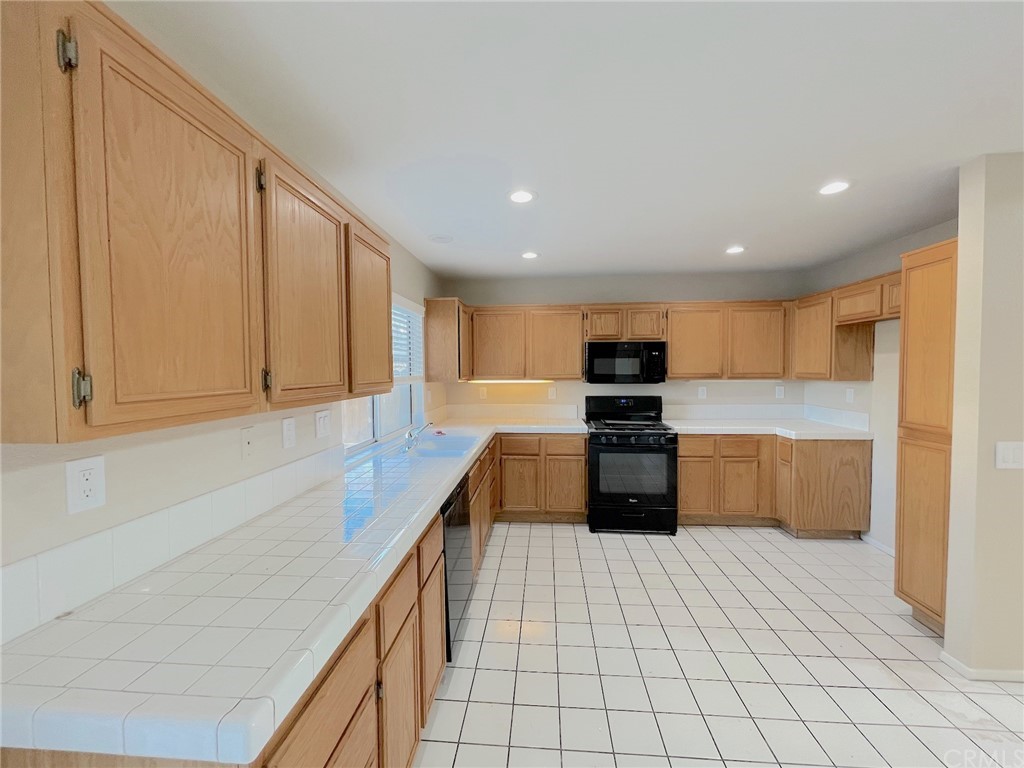 651 Pointe Vista Lane Corona, CA 92881 - Photo 5 of 19 a kitchen with stainless steel appliances granite countertop a refrigerator and a sink