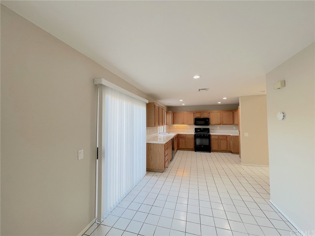 651 Pointe Vista Lane Corona, CA 92881 - Photo 8 of 19 a view of a kitchen with a sink and a refrigerator
