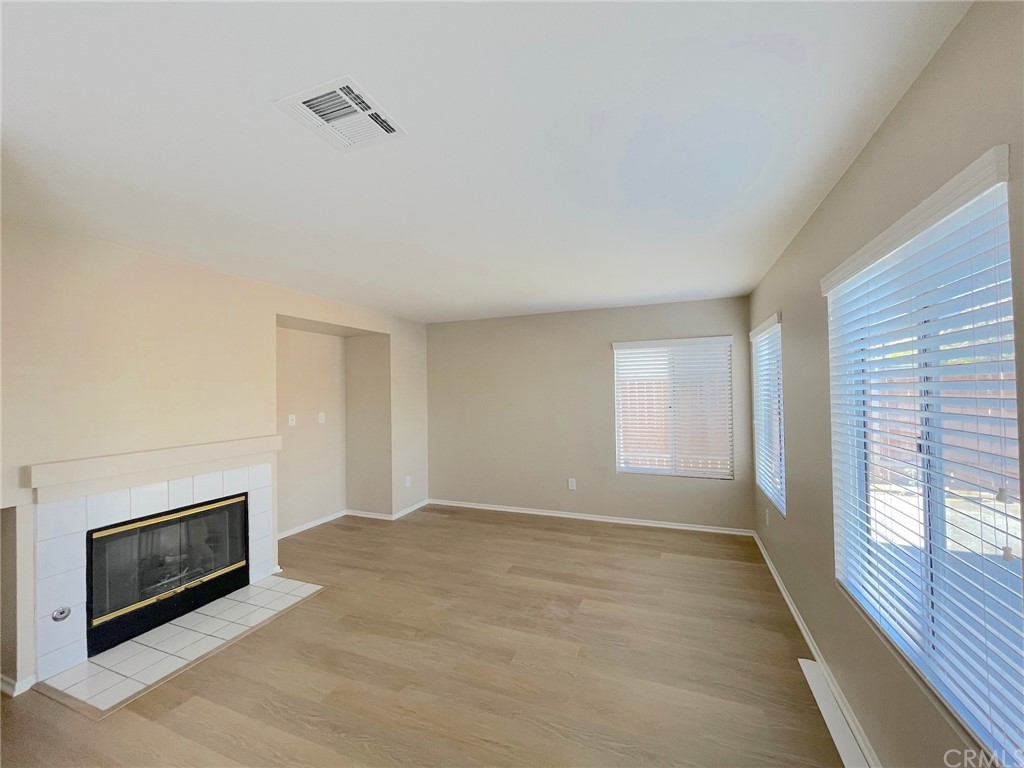 651 Pointe Vista Lane Corona, CA 92881 - Photo 10 of 19 a view of an empty room with wooden floor and a window