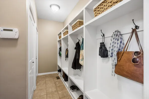 a bathroom with a double vanity sink a toilet and shower