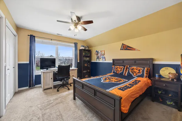 a bedroom with a bed and a chandelier
