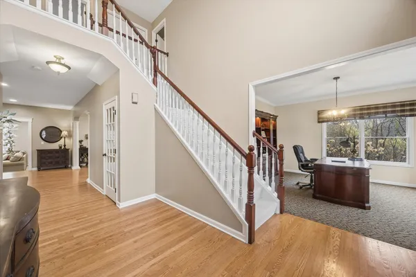 a living room with furniture a fireplace and wooden floor