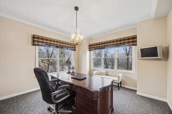 a kitchen with stainless steel appliances granite countertop a dining table chairs stove and refrigerator