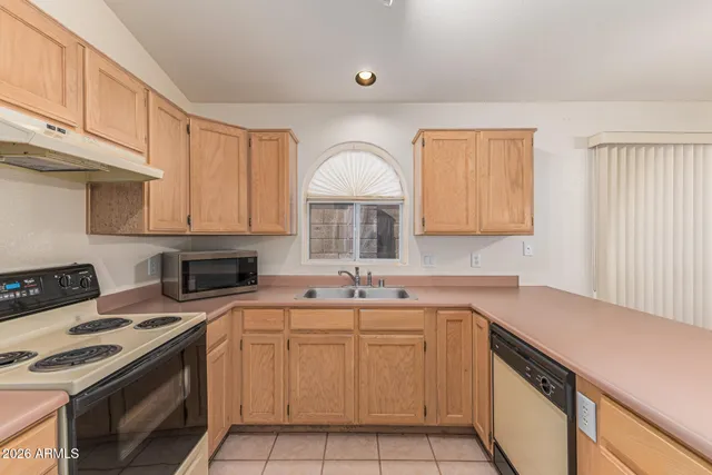 a kitchen with a sink stove top oven and cabinets