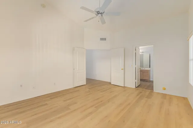 a view of an empty room with a ceiling fan
