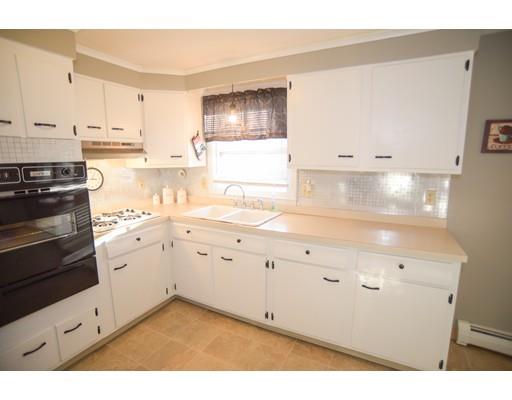 40 Gardner Road Chicopee, MA 01013 - Photo 9 of 30 a kitchen with granite countertop white cabinets and white appliances