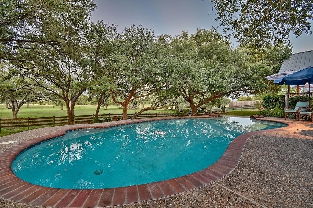 8456 Schuster Road Ledbetter, TX 78946 - Photo 36 of 49 a view of a swimming pool with an outdoor space