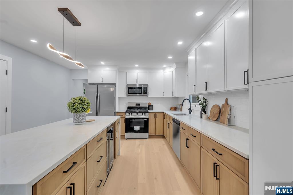 76 Point View Parkway Wayne, NJ 07470 - Photo 12 of 44 a kitchen with kitchen island granite countertop lots of counter top space and wooden floor