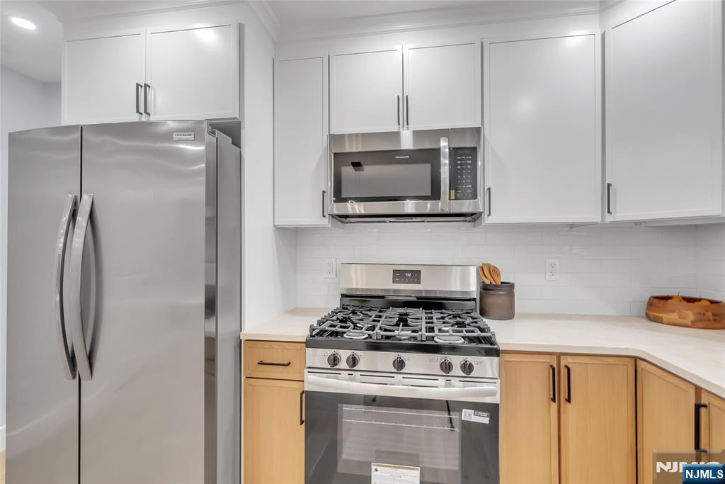 76 Point View Parkway Wayne, NJ 07470 - Photo 13 of 44 a kitchen with stainless steel appliances granite countertop a stove a refrigerator and a microwave