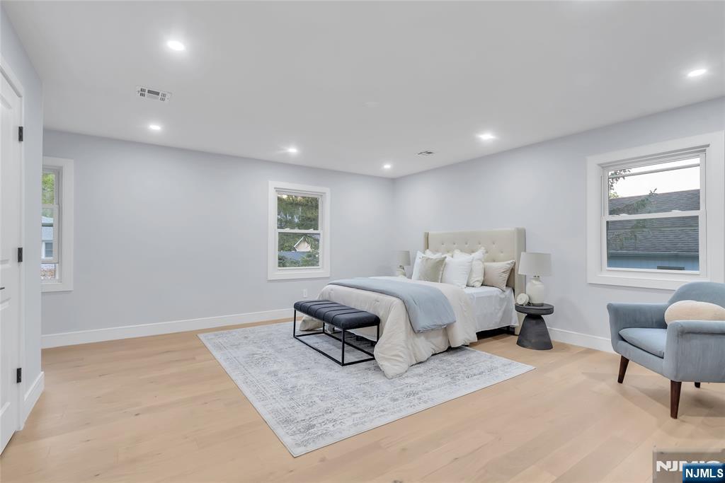 76 Point View Parkway Wayne, NJ 07470 - Photo 24 of 44 a spacious bedroom with a bed a couch and window