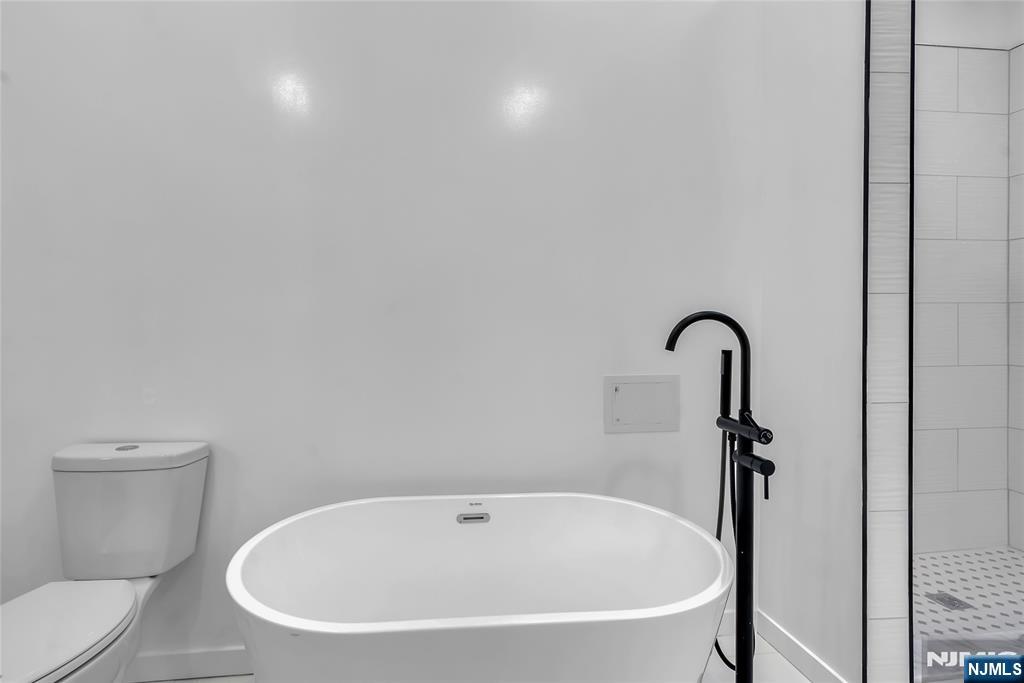 76 Point View Parkway Wayne, NJ 07470 - Photo 26 of 44 a white bath tub sitting next to a toilet