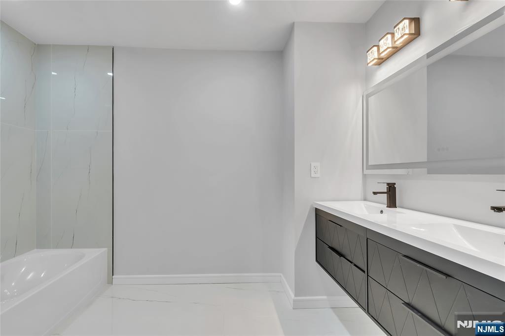 76 Point View Parkway Wayne, NJ 07470 - Photo 31 of 44 a bathroom with a bathtub a sink and a mirror