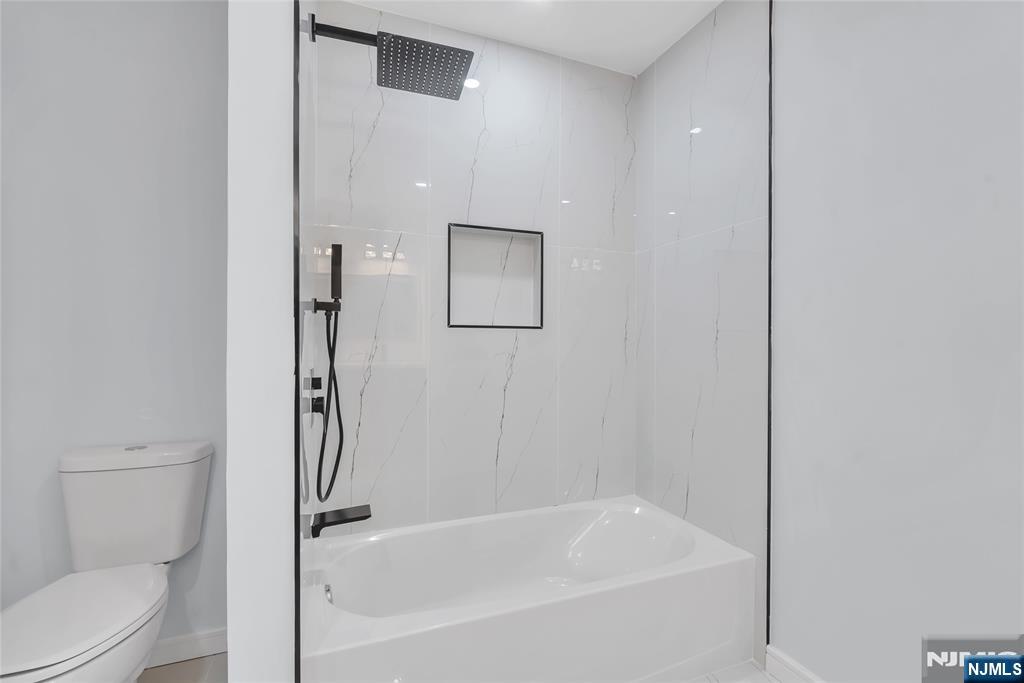 76 Point View Parkway Wayne, NJ 07470 - Photo 32 of 44 a white bath tub sitting next to a toilet