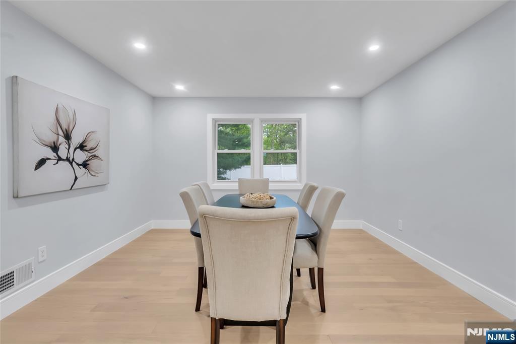 76 Point View Parkway Wayne, NJ 07470 - Photo 9 of 44 a view of a dining room with furniture a couch and wooden floor