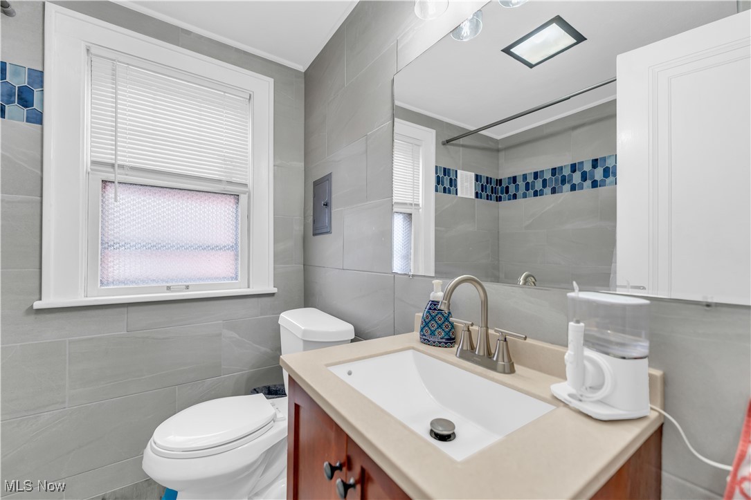 3729 Grosvenor Road Cleveland, OH 44118 - Photo 32 of 39 Full bath with vanity, ornamental molding, a shower, tile walls, and toilet