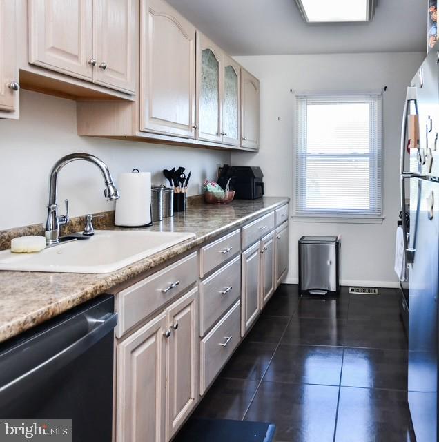 120 Old Enterprise Road, Unit 115 Upper Marlboro, MD 20774 - Photo 13 of 43 a kitchen with stainless steel appliances granite countertop a sink dishwasher a stove and white cabinets with wooden floor