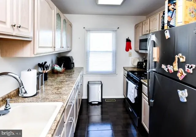 a kitchen with stainless steel appliances granite countertop a refrigerator sink and cabinets