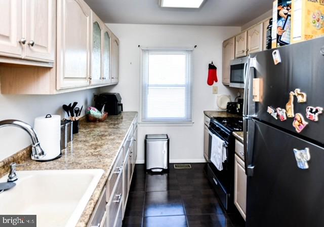 120 Old Enterprise Road, Unit 115 Upper Marlboro, MD 20774 - Photo 14 of 43 a kitchen with stainless steel appliances granite countertop a refrigerator sink and cabinets