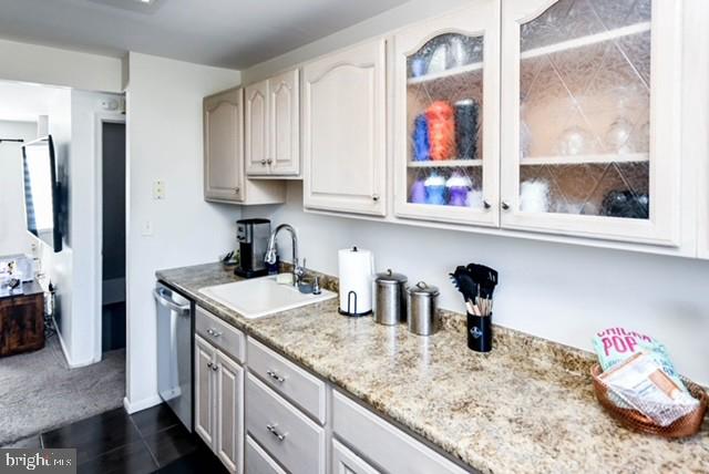 120 Old Enterprise Road, Unit 115 Upper Marlboro, MD 20774 - Photo 16 of 43 a kitchen with sink and lots of wooden cabinets