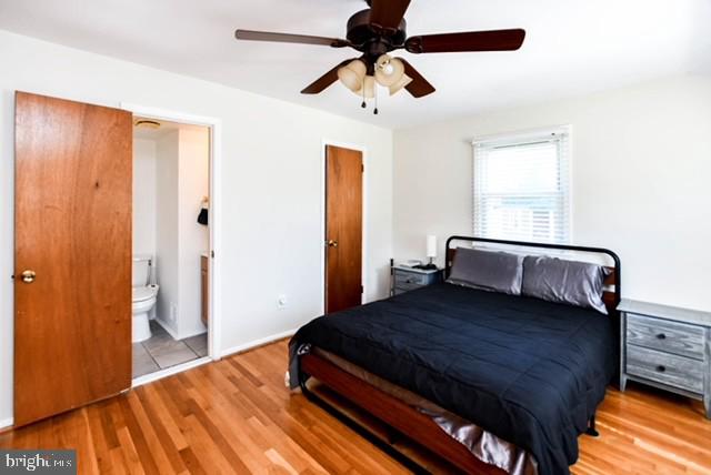 120 Old Enterprise Road, Unit 115 Upper Marlboro, MD 20774 - Photo 24 of 43 a bedroom with a bed and wooden floor