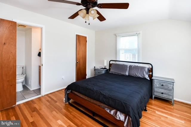120 Old Enterprise Road, Unit 115 Upper Marlboro, MD 20774 - Photo 25 of 43 a bedroom with a bed and wooden floor