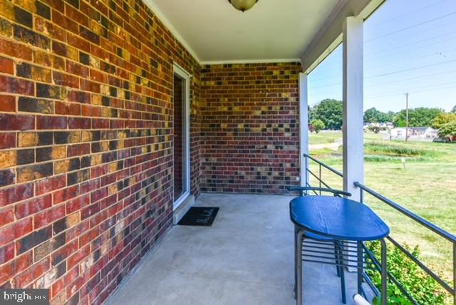 120 Old Enterprise Road, Unit 115 Upper Marlboro, MD 20774 - Photo 3 of 43 a view of balcony with a table and chair