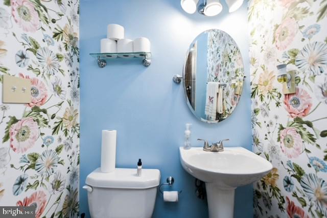 120 Old Enterprise Road, Unit 115 Upper Marlboro, MD 20774 - Photo 37 of 43 a bathroom with a sink and mirror with toilet