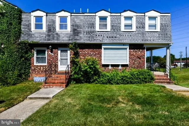 a view of a brick building next to a yard