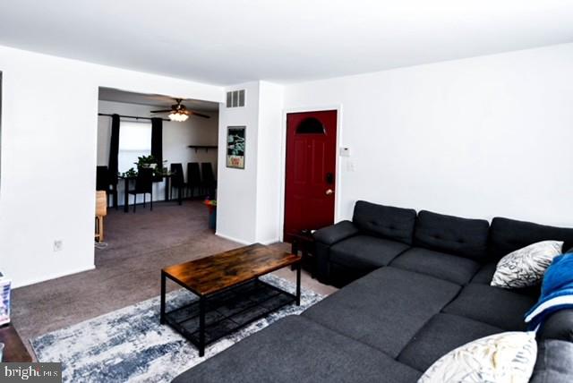 120 Old Enterprise Road, Unit 115 Upper Marlboro, MD 20774 - Photo 7 of 43 a living room with furniture and a table