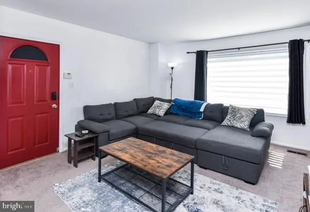 a living room with furniture and a window