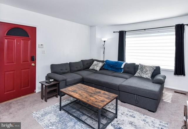 120 Old Enterprise Road, Unit 115 Upper Marlboro, MD 20774 - Photo 8 of 43 a living room with furniture and a window