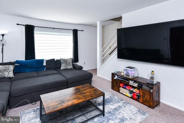 120 Old Enterprise Road, Unit 115 Upper Marlboro, MD 20774 - Photo 9 of 43 a living room with furniture and a flat screen tv