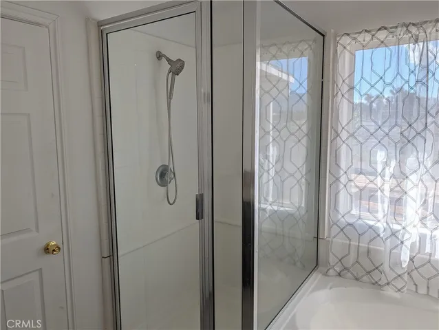a bathroom with a glass shower door