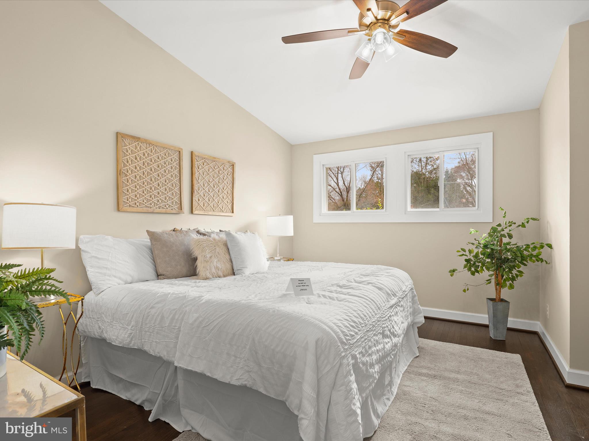 4708 Maryknoll Road Baltimore, MD 21208 - Photo 17 of 44 a bedroom with a large bed and a chandelier