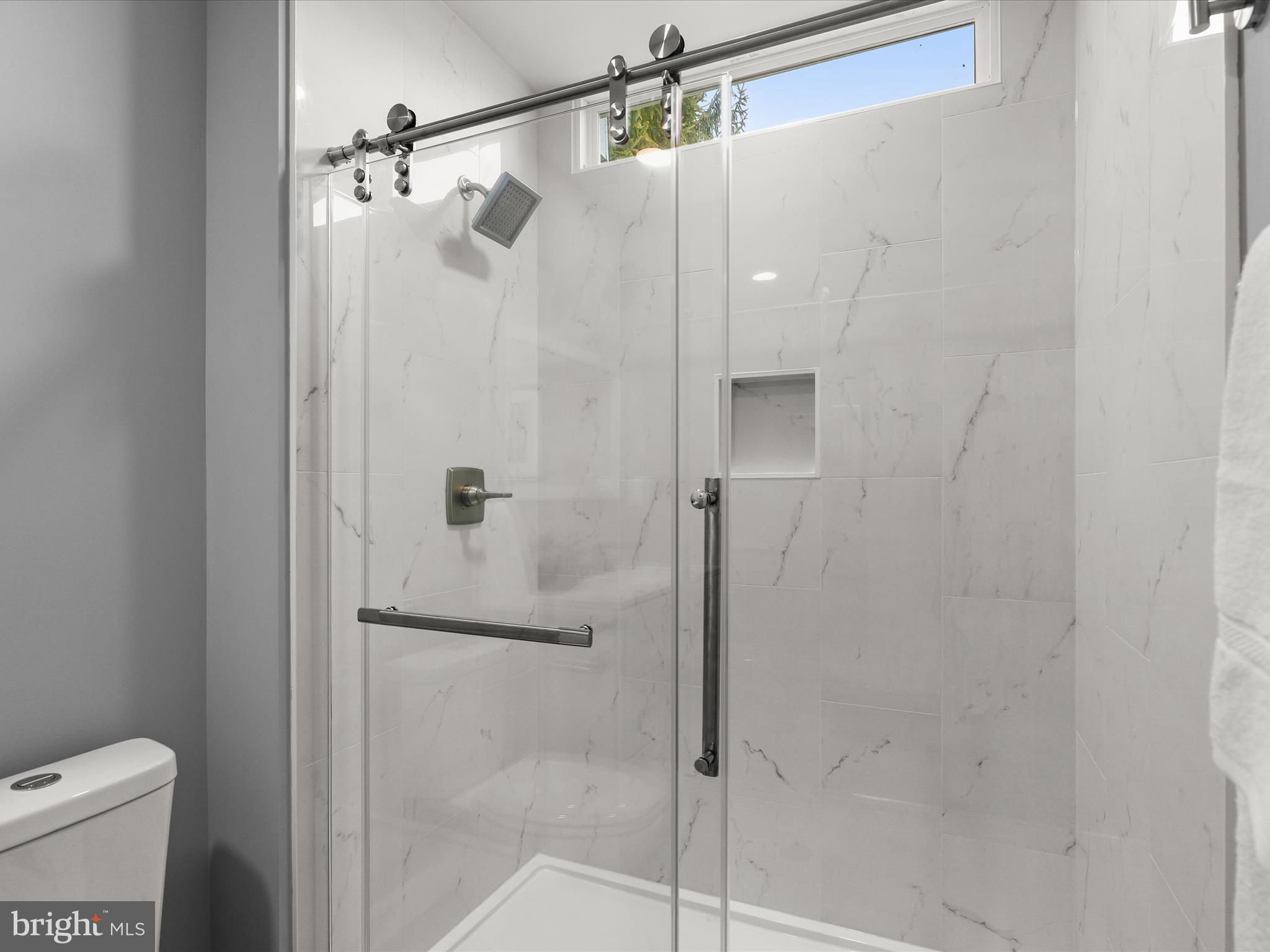 4708 Maryknoll Road Baltimore, MD 21208 - Photo 19 of 44 a bathroom with a shower and toilet