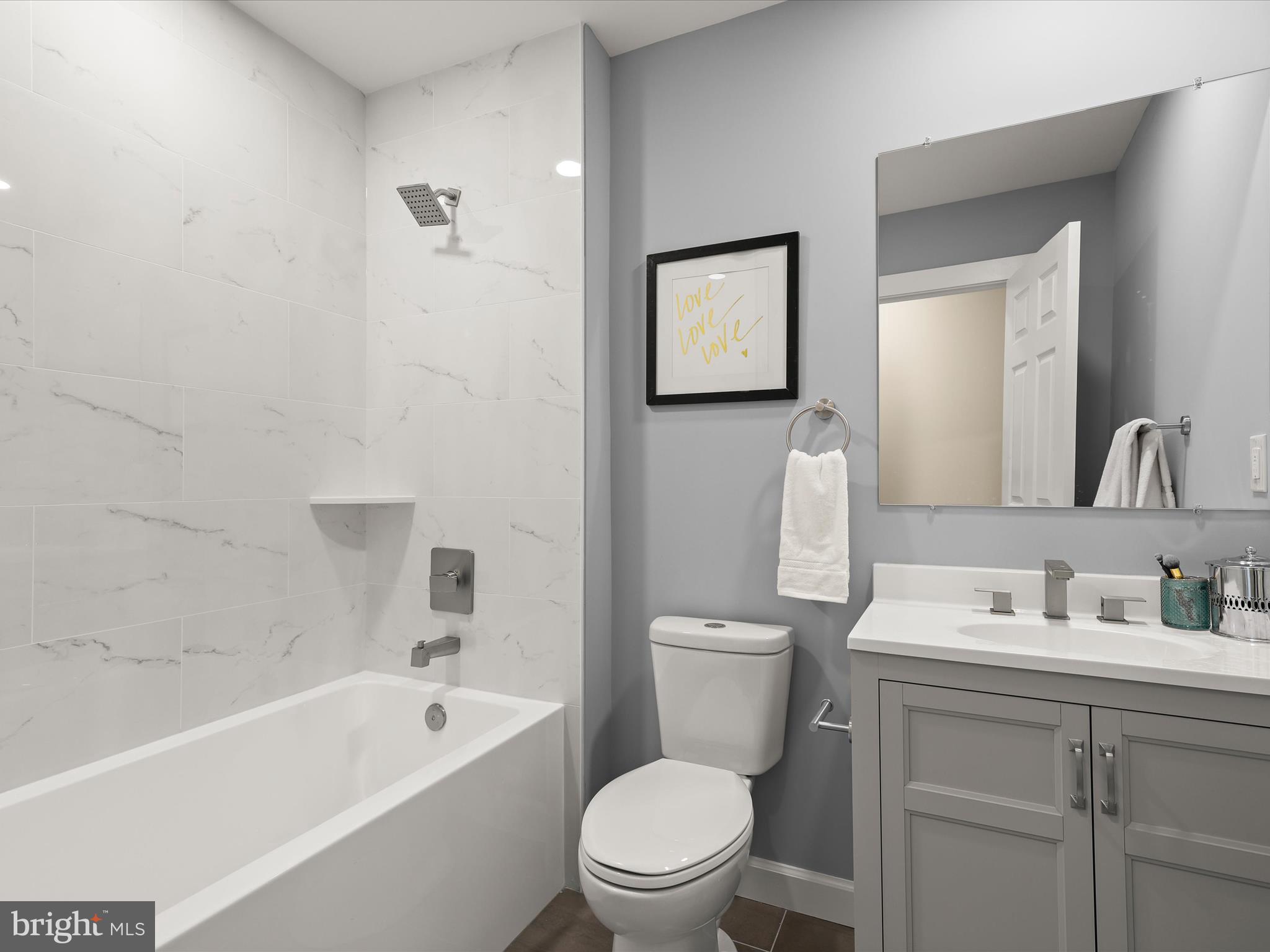 4708 Maryknoll Road Baltimore, MD 21208 - Photo 23 of 44 a bathroom with a toilet a sink a mirror a bathtub and vanity