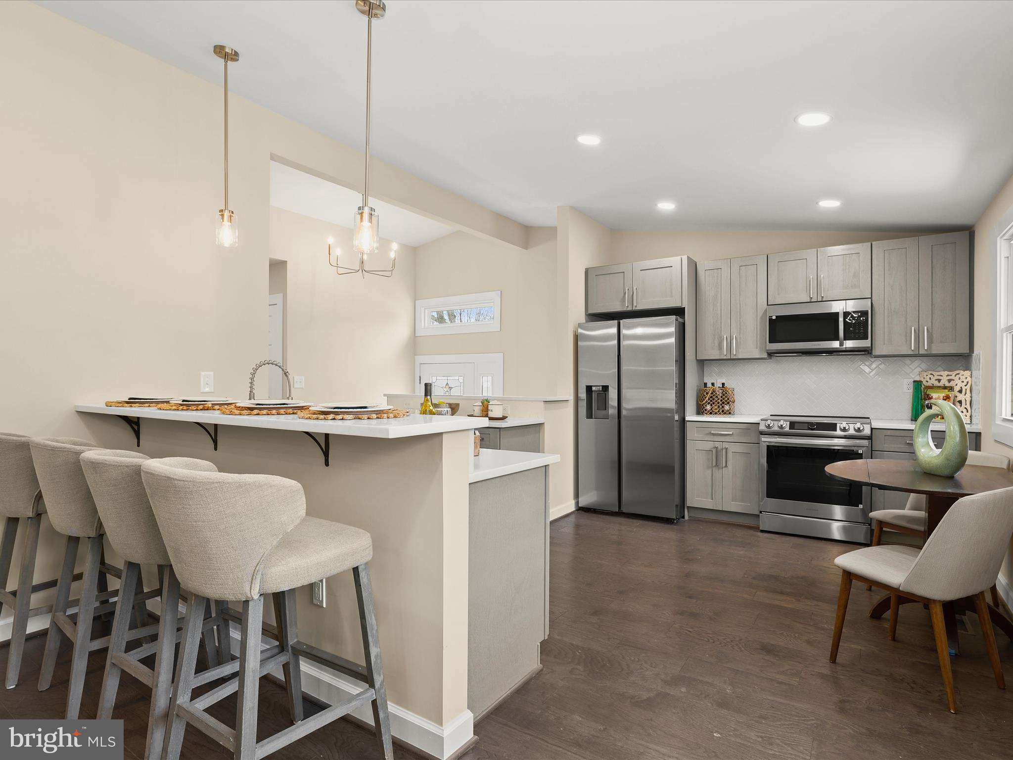 4708 Maryknoll Road Baltimore, MD 21208 - Photo 2 of 44 a kitchen with kitchen island a dining table chairs sink and microwave