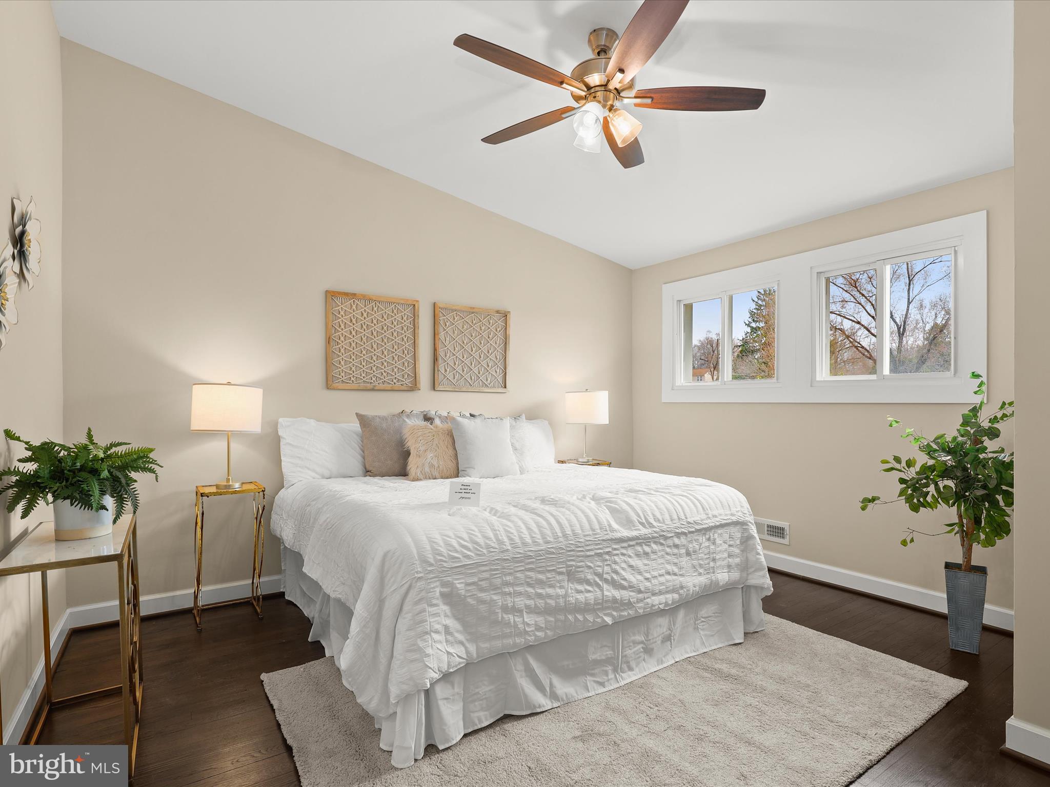 4708 Maryknoll Road Baltimore, MD 21208 - Photo 4 of 44 a bedroom with a large bed and a chandelier