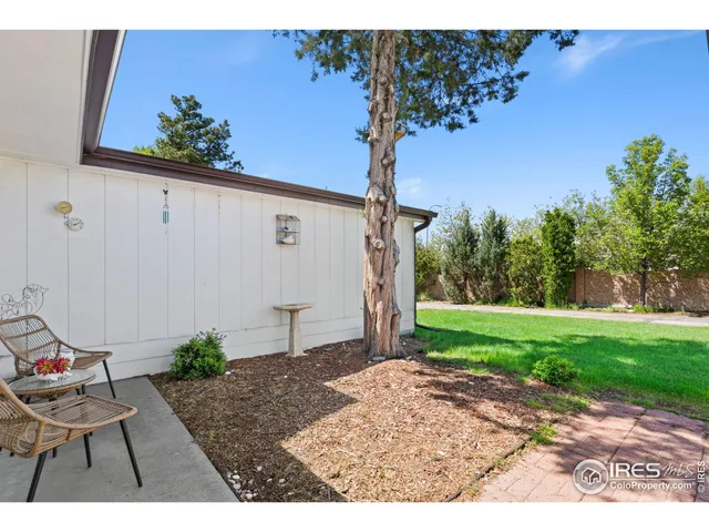 a view of a backyard with sitting area
