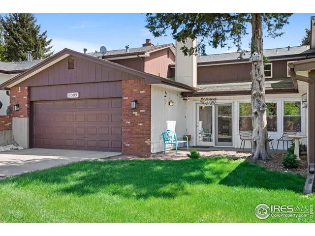 a view of a house with a yard and sitting area