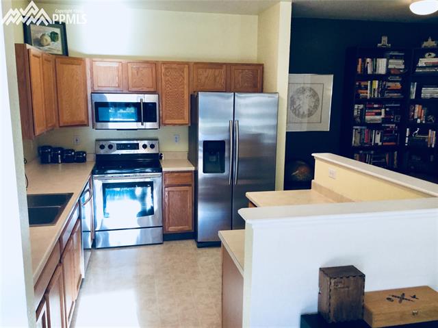2095 Legacy Ridge View, Unit 112 Colorado Springs, CO 80910 - Photo 4 of 28 Kitchen with newer stainless appliances all staying!