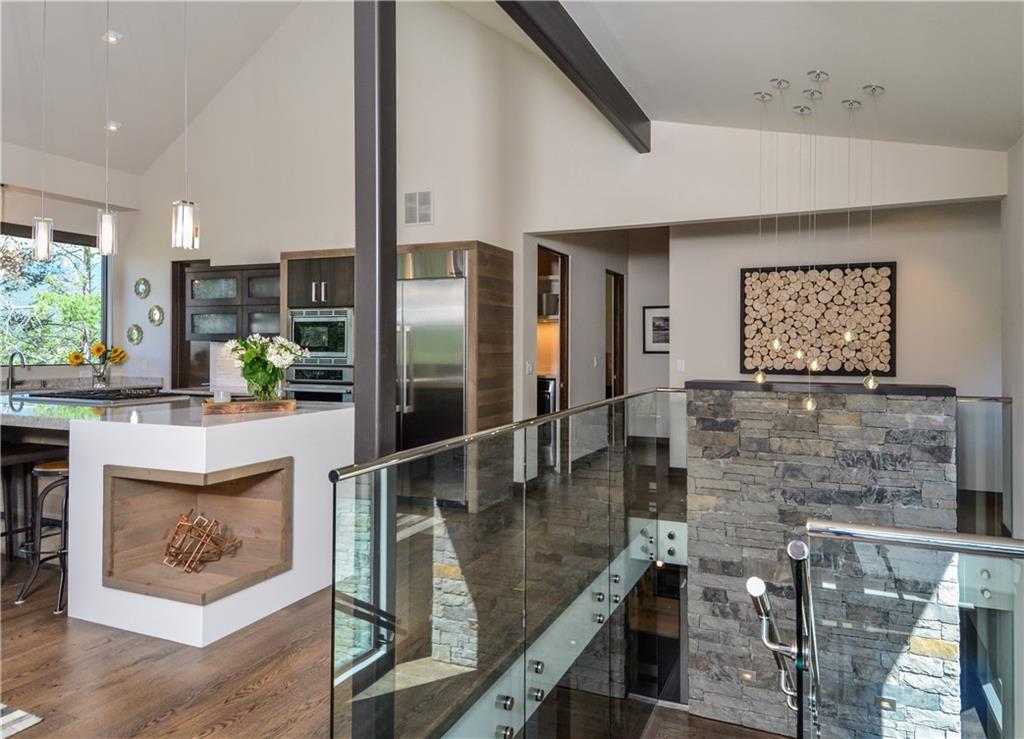 33 Rounds Road Breckenridge, CO 80424 - Photo 11 of 25 a kitchen with kitchen island granite countertop a refrigerator a stove and a wooden floor