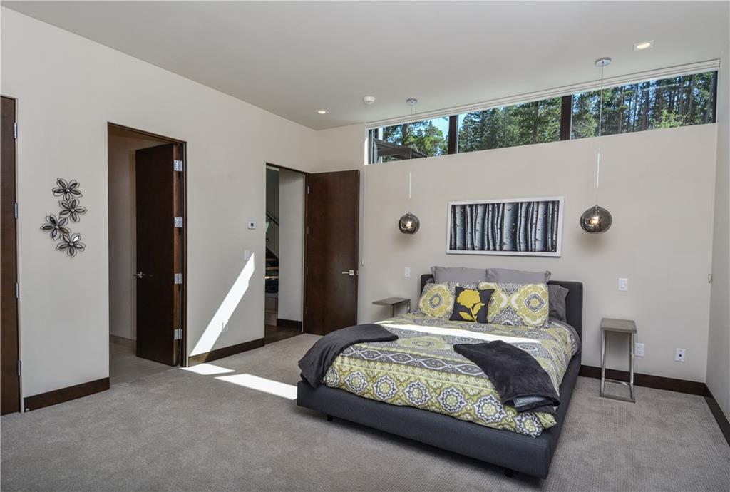33 Rounds Road Breckenridge, CO 80424 - Photo 16 of 25 a bedroom with a large bed and a chandelier