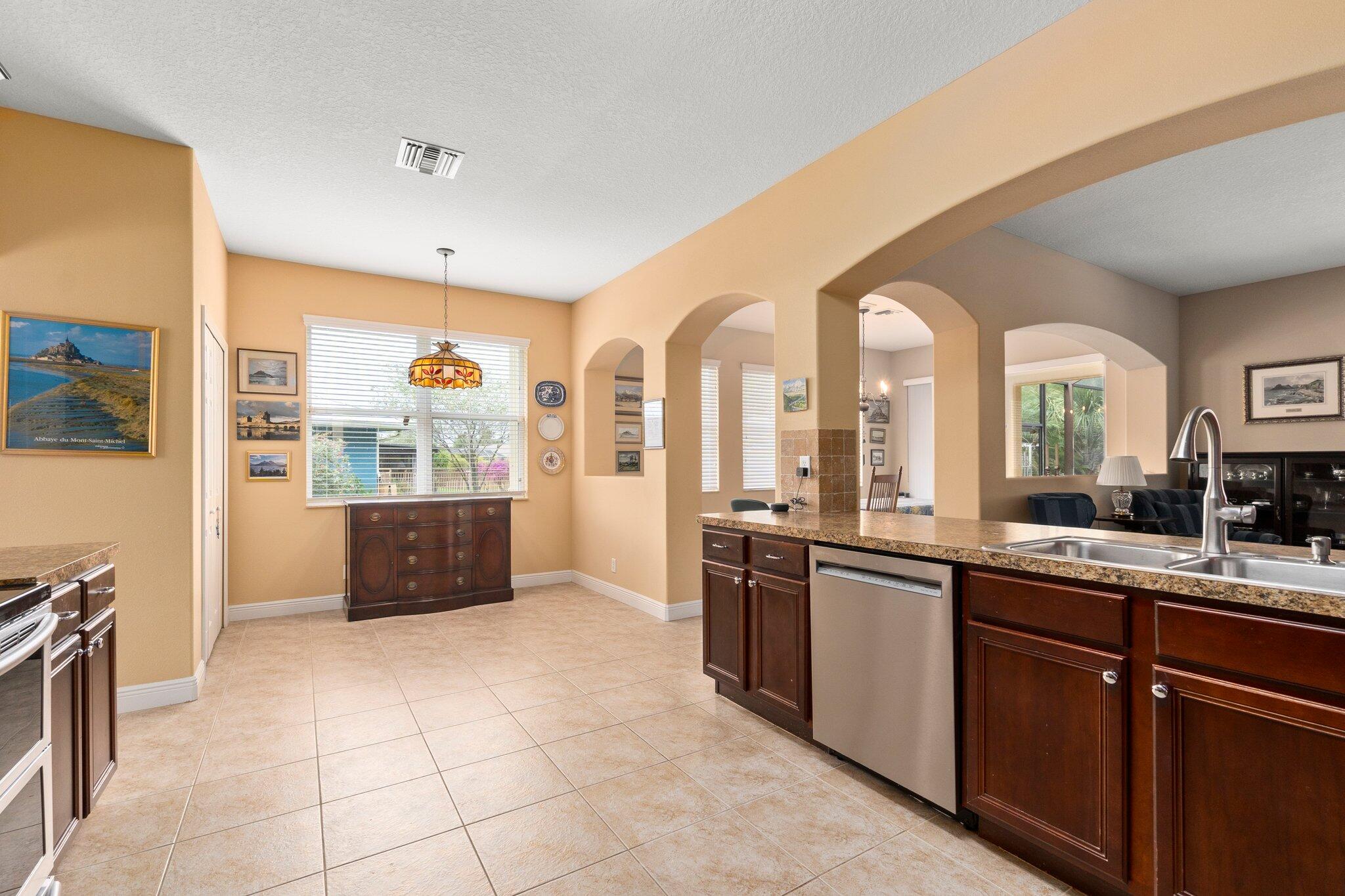 2309 Southwest Ivory Road Port St. Lucie, FL 34953 - Photo 13 of 46 a large white kitchen with a large window
