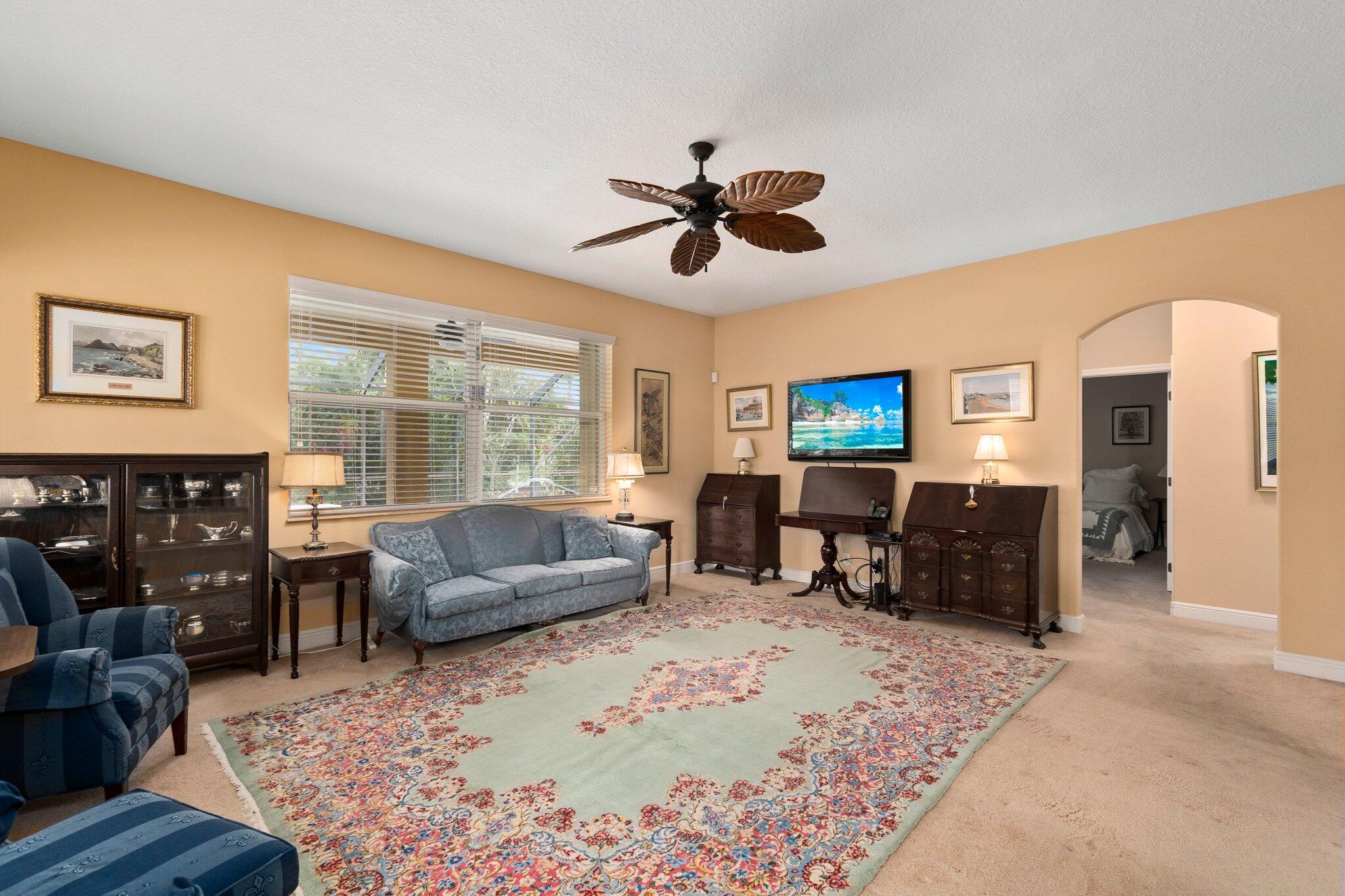 2309 Southwest Ivory Road Port St. Lucie, FL 34953 - Photo 16 of 46 a living room with furniture and a flat screen tv